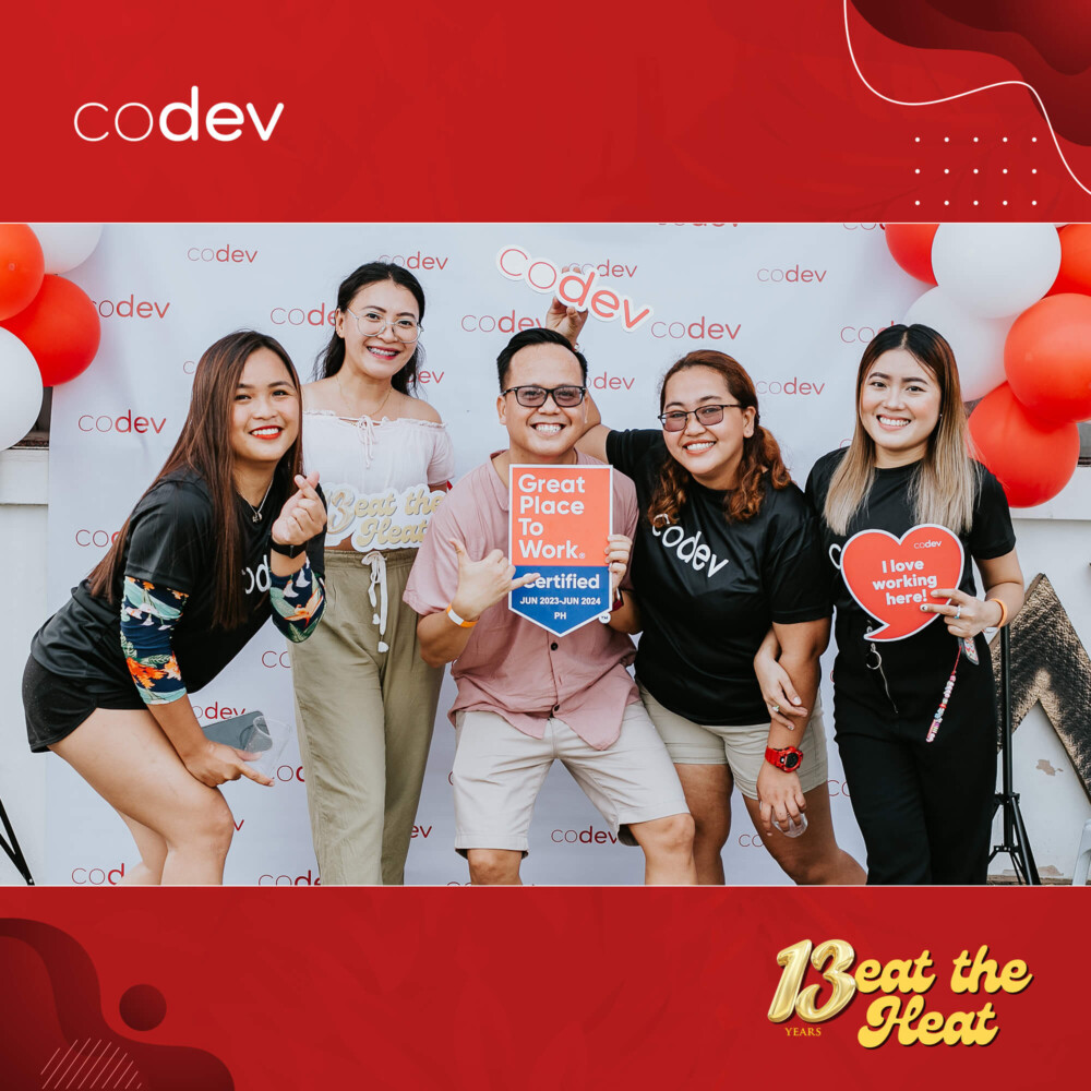 CoDev employees take photobooth pictures featuring the Great Place To Work badge.